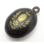 A Victorian faux tortoiseshell pendant locket with inlaid pique work detail. Hinging open to