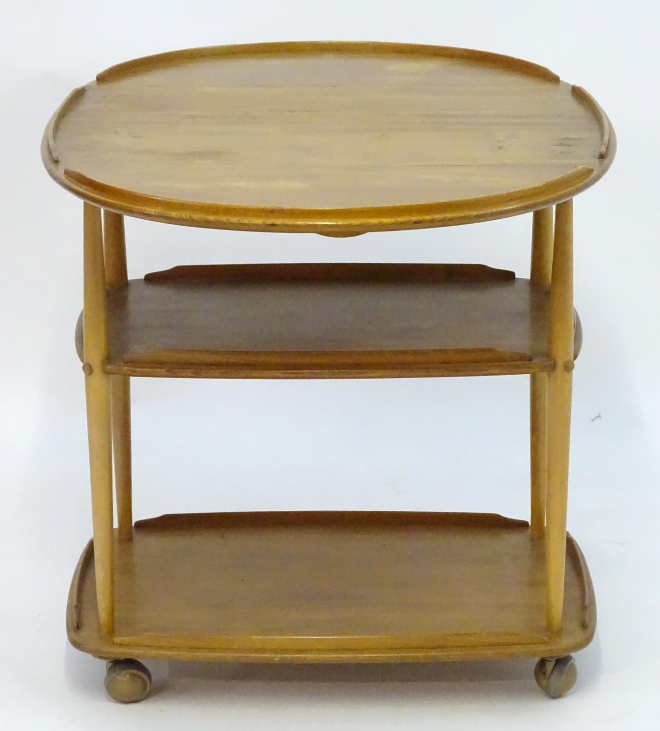 Vintage Retro, Mid-Century: an Ercol elm and beech three tiered trolley, the top with drop flaps, - Image 2 of 5