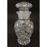 Glass: a 20thC cut crystal decanter, decorated with star, hobnail and block cuts, the next with dual