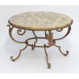 A mid 20thC Art Deco low table with a circular marble top and a gilt metal base with four scrolled
