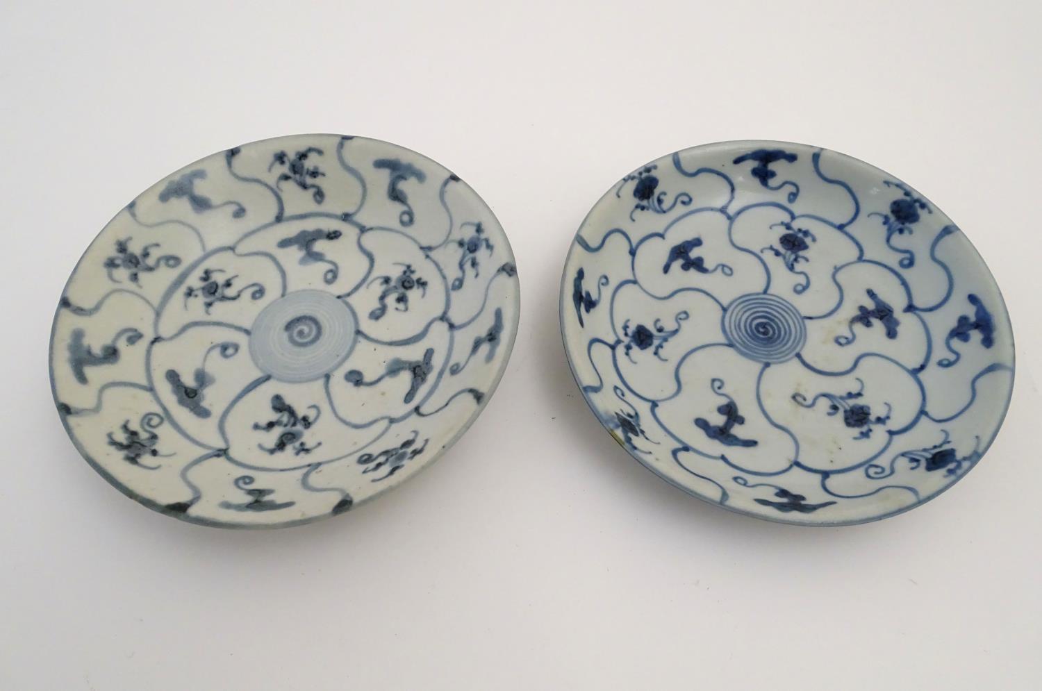 Two Chinese blue and white Tek Sing plates with central roundels with radiating cells decorated with