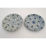 Two Chinese blue and white Tek Sing plates with central roundels with radiating cells decorated with