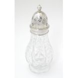 A cut glass sugar caster / muffineer marked Edinburgh crystal, with silver mounts and top,