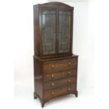 An early 19thC rosewood secretaire bookcase with an arched pediment above two astragal glazed doors,