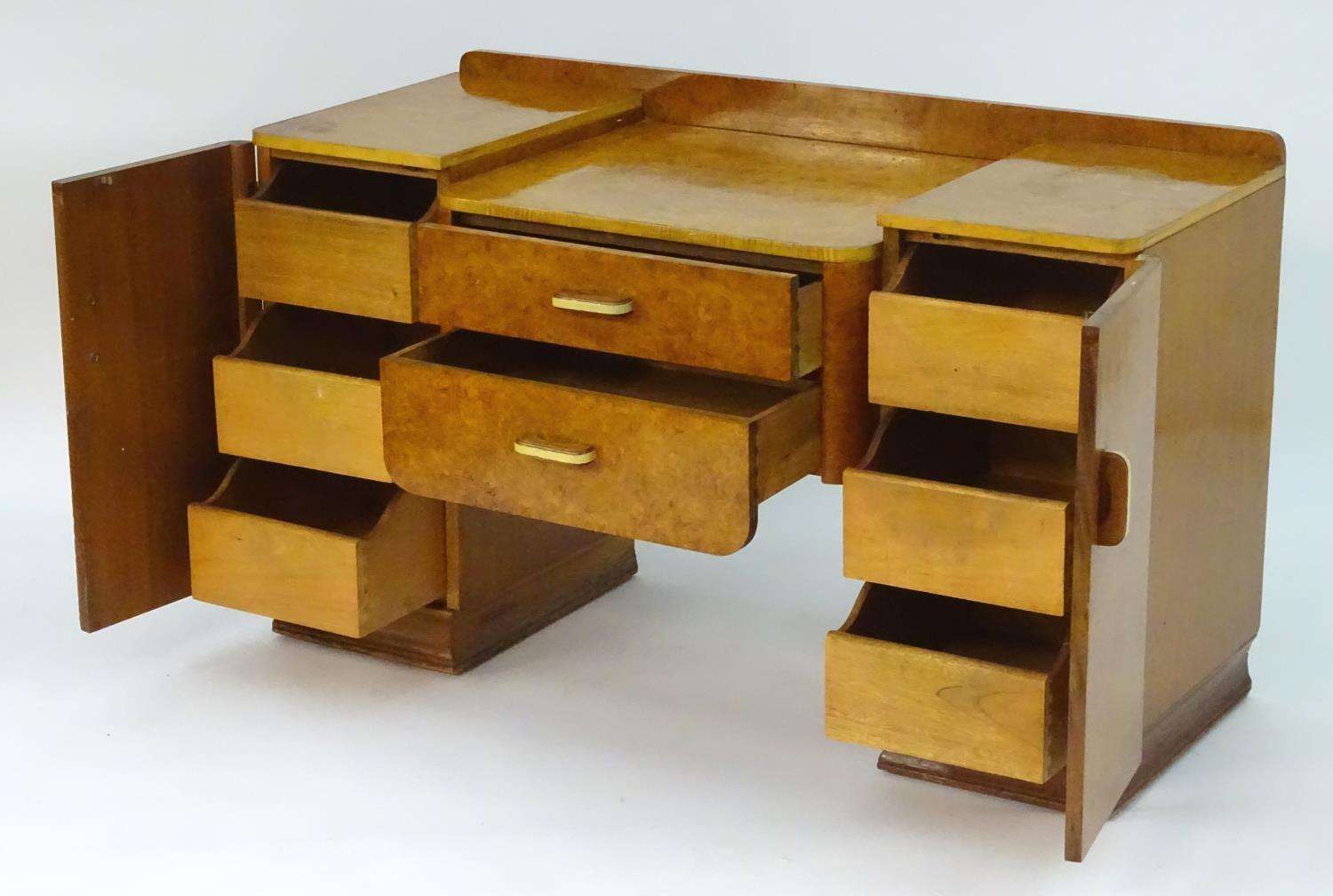 A mid 20thC burr walnut dressing table with two short drawers flanked by cupboards to each side. 48" - Image 4 of 7