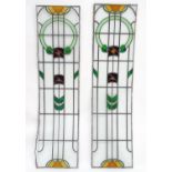 Two early 20thC large stained glass window panes / panels with stylised flower and geometric detail.