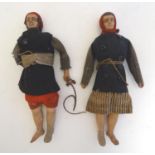 A pair of naive early 20thC primitive dolls formed as a man and a woman with ceramic heads, arms and