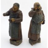 Two late 19th / early 20thC plaster figures with a terracotta finish formed as monks / friars