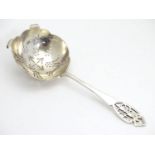 A silver tea strainer with pierced decoration. Hallmarked Sheffield 1954 maker HH. 42g Please Note -