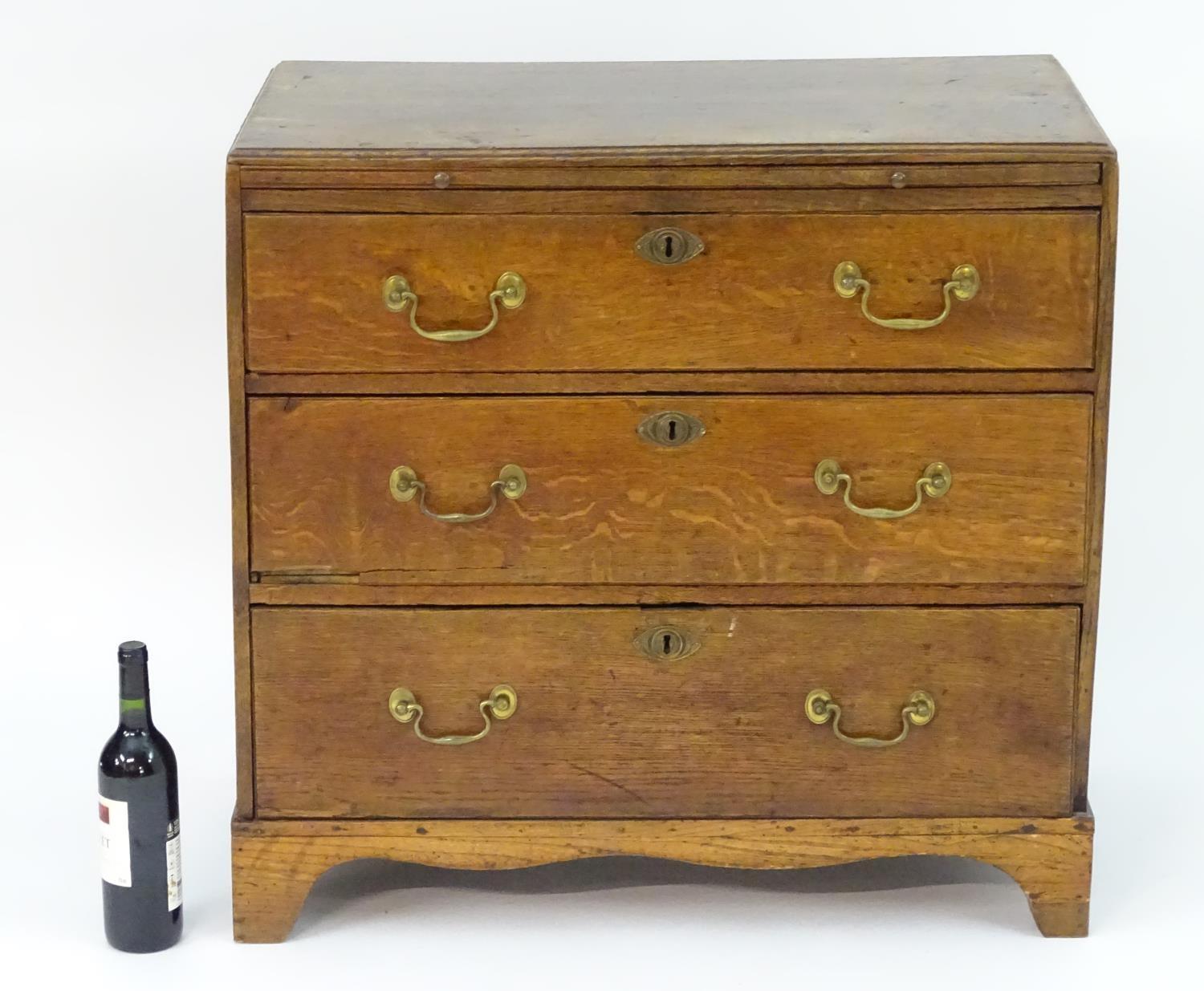 A mid 18thC oak chest of drawers with a rectangular top above a brushing slide and three long - Image 2 of 7