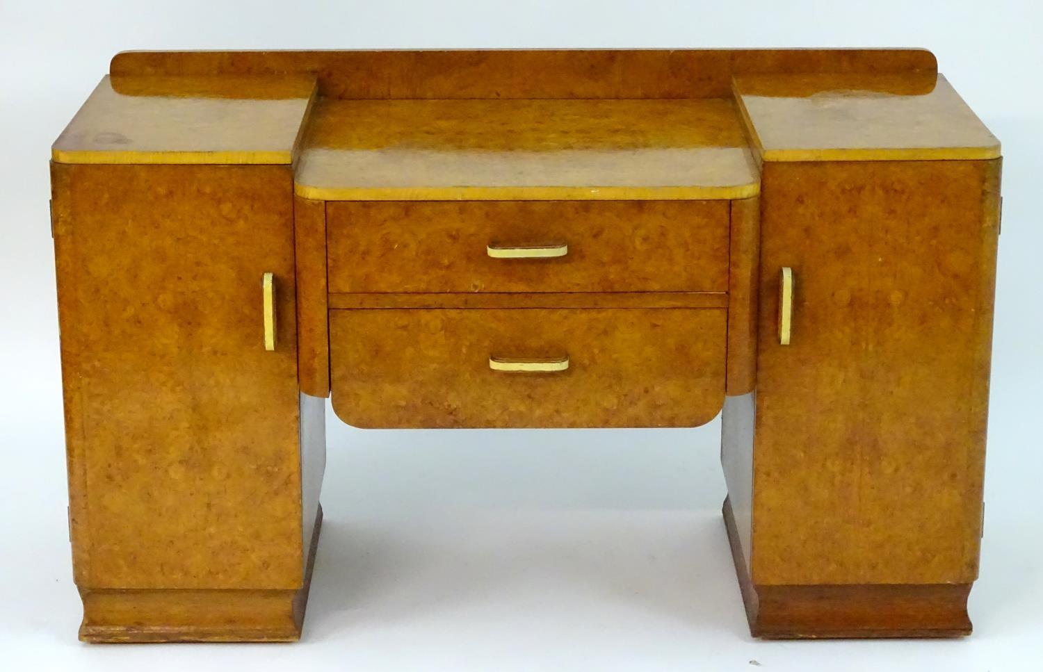 A mid 20thC burr walnut dressing table with two short drawers flanked by cupboards to each side. 48" - Image 3 of 7