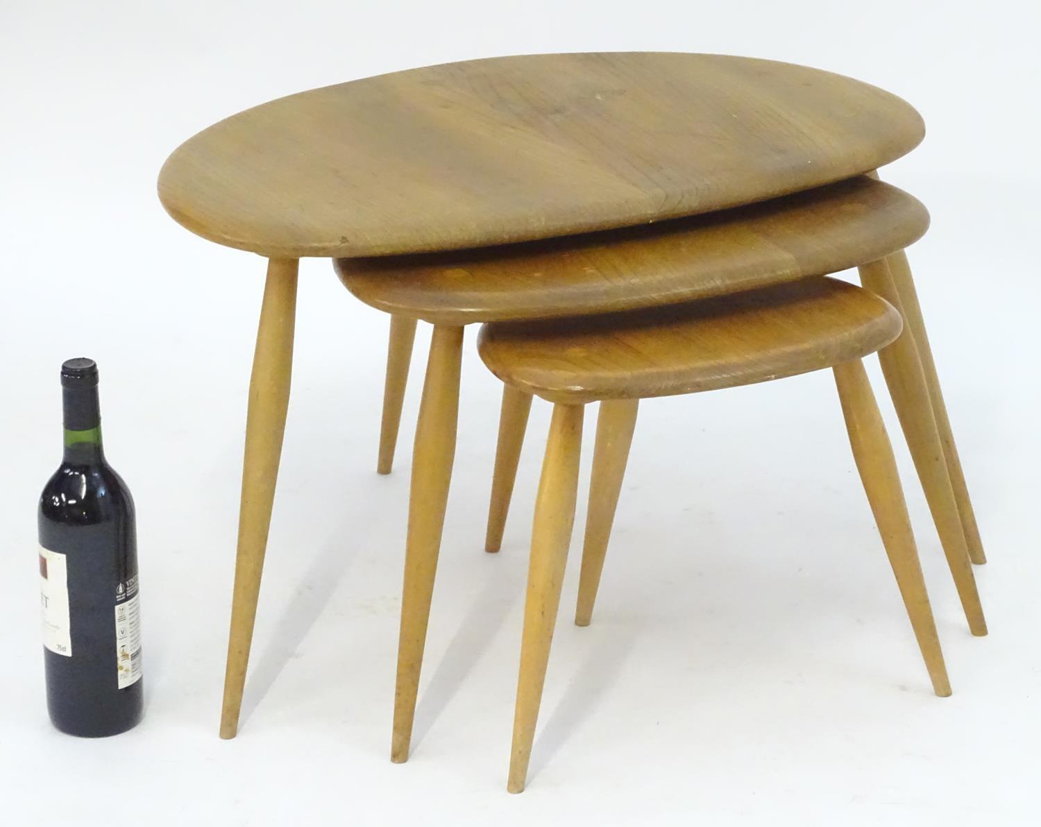 Vintage Retro, Mid-Century: an Ercol elm and beech graduated nest of three tripod tables, the - Image 2 of 4