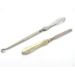 A silver handled button hook hallmarked Birmingham 1916 and a silver handled manicure tool (2)