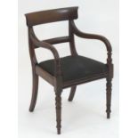 A mid 19thC mahogany open armchair with a shaped top rail and mid rail above a drop in seat and