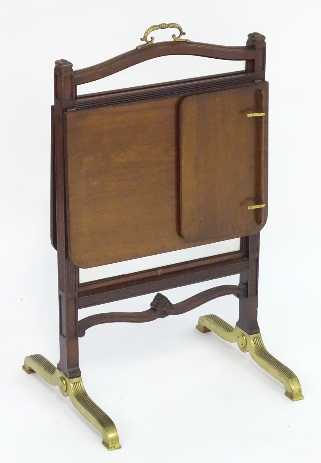 An unusual 19thC metamorphic reading table / fire screen. Having a sliding glass screen with a brass