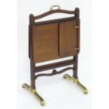 An unusual 19thC metamorphic reading table / fire screen. Having a sliding glass screen with a brass