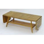 Vintage Retro, Mid-Century: an Ercol elm and beech coffee table, extending with drop flaps, standing