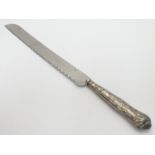 A silver handled King?s Pattern bread knife. Hallmarked Sheffield 1972 maker Harrison Brothers. 12