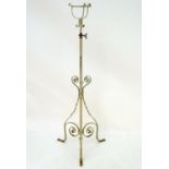 Lighting: a late-Victorian wrought iron and copper lamp stand, with white painted finish,