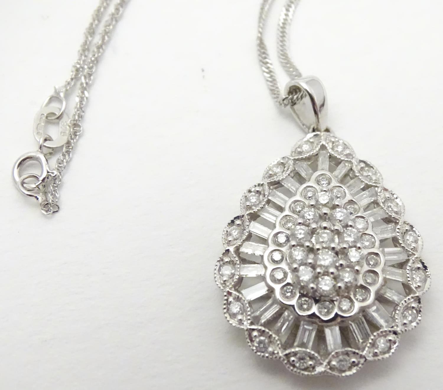 A 9ct white gold pendant set with a profusion of diamonds, on an 18" long and. The pendant approx 1" - Image 5 of 7