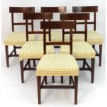 A set of six Georgian mahogany dining chairs with boxwood stringing, shaped mid rail and top rail