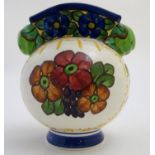 An Alumina faience globular vase with a squared rim and floral decoration. Marked under with