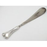A silver handled shoe horn hallmarked Birmingham 1908 9 1/2" long Please Note - we do not make