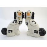 Two pairs of Staffordshire mantel dogs by Arthur Wood, one pair black and white, the other pair