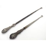 Two silver handled button hooks, one with floral and C scroll decoration hallmarked Birmingham