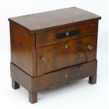 A 19thC mahogany continental chest of drawers with a rectangular top above three long drawers with