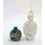 An early 20thC art glass scent bottle, with waved marbled decoration, together with a squat scent