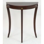 A mahogany demi lune table with gilt metal rosette decoration and shaped legs. 24" wide x 12" deep x