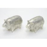 A 21stC novelty silver plated salt and pepper cruet formed as pigs. Approx 2 1/2" long Please Note -