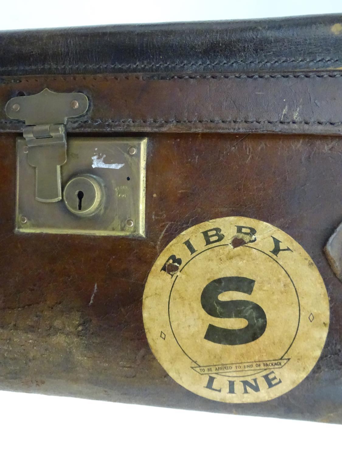 A late 19thC leather travelling trunk flanked by carrying handles. 34" long x 19" wide x 11" high. - Image 9 of 10