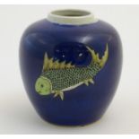 A Chinese vase with a cobalt blue ground decorated with three hand painted fish. Approx. 5 1/2" high