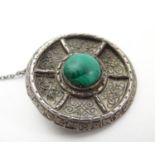A silver brooch of circular form wit engraved decoration and central malachite cabochon 1 1/4"