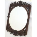 A 19thC rosewood mirror with a pierced and carved top and bottom, depicting anthemion in flower