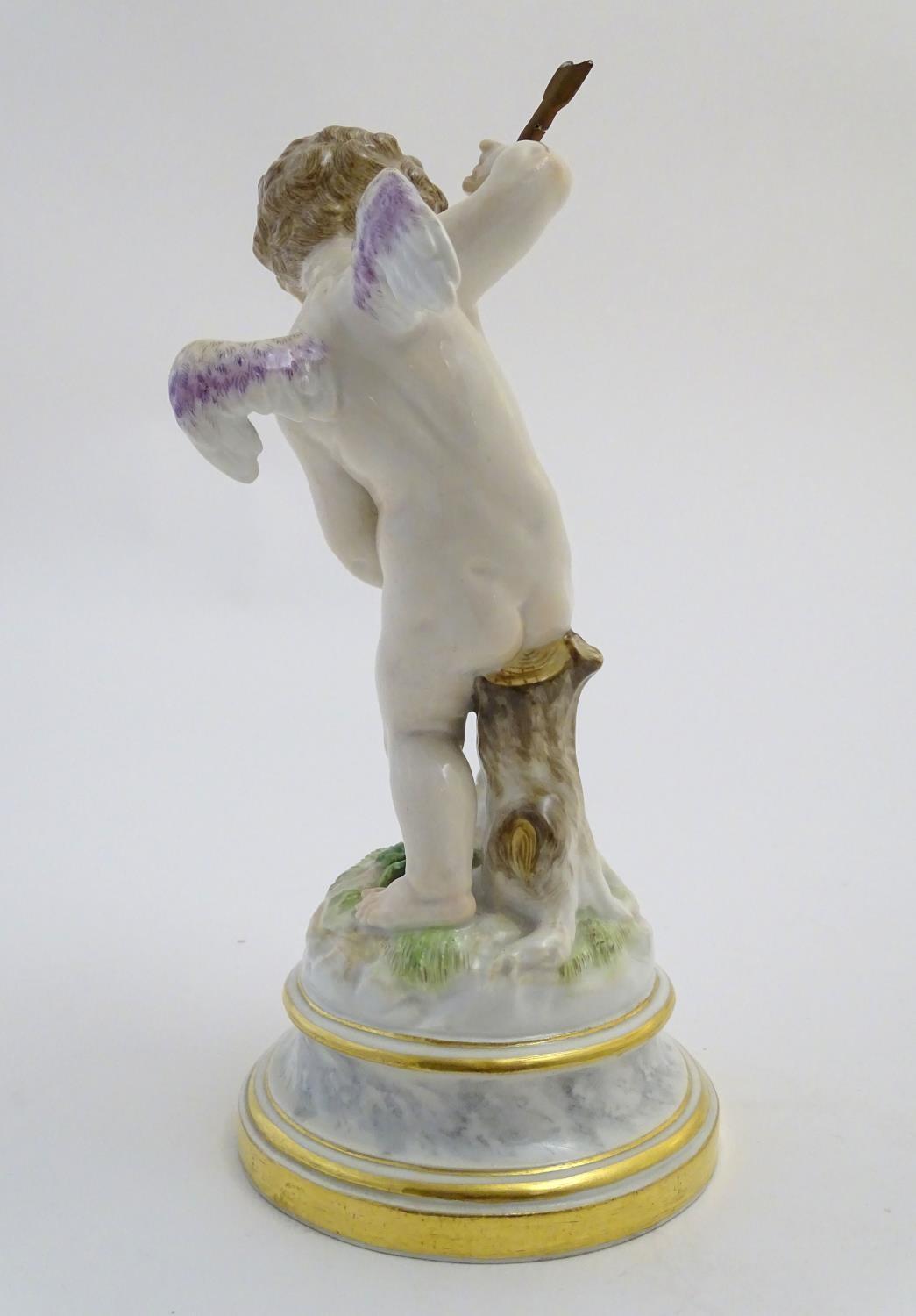 A late 19thC Meissen figure of Cupid holding an arrow and a flaming heart. On a naturalistic base. - Image 5 of 9