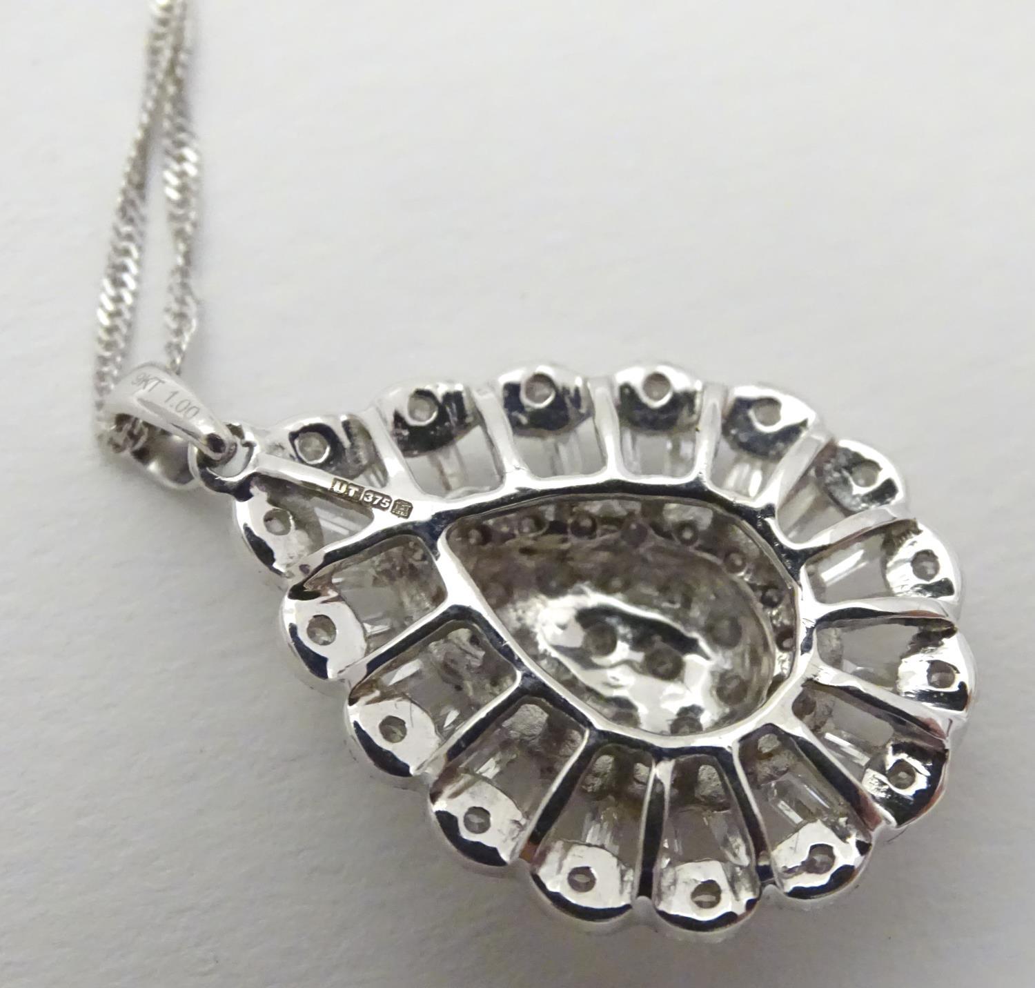 A 9ct white gold pendant set with a profusion of diamonds, on an 18" long and. The pendant approx 1" - Image 6 of 7
