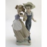 A Lladro figural group depicting a girl and boy with flowers, Love in Bloom, model no. 5292. Approx.