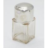 A glass scent bottle with silve rlid having gilding to interior of lid. Hallmarked Birmingham 1908