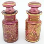 A pair of 19thC cranberry glass jars, each decorated with hand painted vines and bands. 7 1/2"