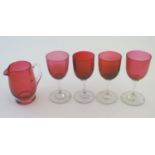 Glass: a set of four Cranberry wine glasses, together with a Cranberry glass jug. The largest 5"