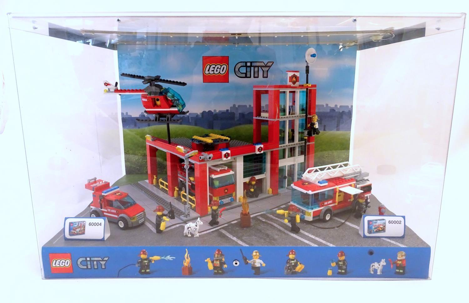 Toy: A Lego City shop display unit featuring a fire station, model no. 60004 and a fire truck, model