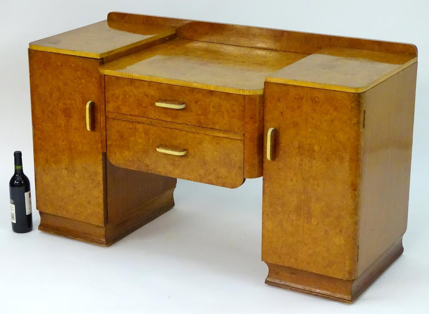 A mid 20thC burr walnut dressing table with two short drawers flanked by cupboards to each side. 48" - Image 6 of 7