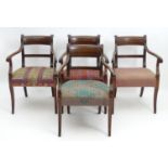 A set of four Regency mahogany carver chairs with scrolled and reeded earpieces and armrests, the