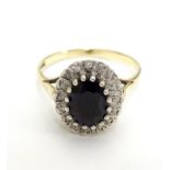 A 9ct gold ring set with facet cut blue spinel bordered by diamonds. Ring size approx N. Please Note