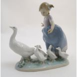 A Lladro figure of a girl with ducks, Hurry Now, model no. 5503. Marked under. Approx. 7" high.