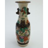 A Chinese crackle glaze vase with twin handles formed as stylised animals, and stylised bixies to