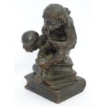 A Victorian novelty cast table lighter modelled as Charles Darwin's The Thinker, a monkey sat upon a